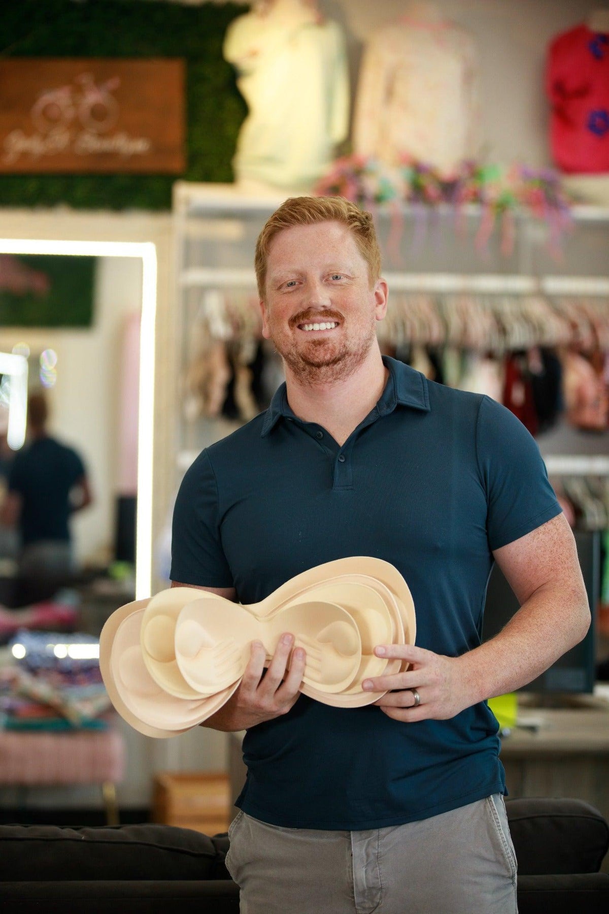 Thad holding connected bralette padding